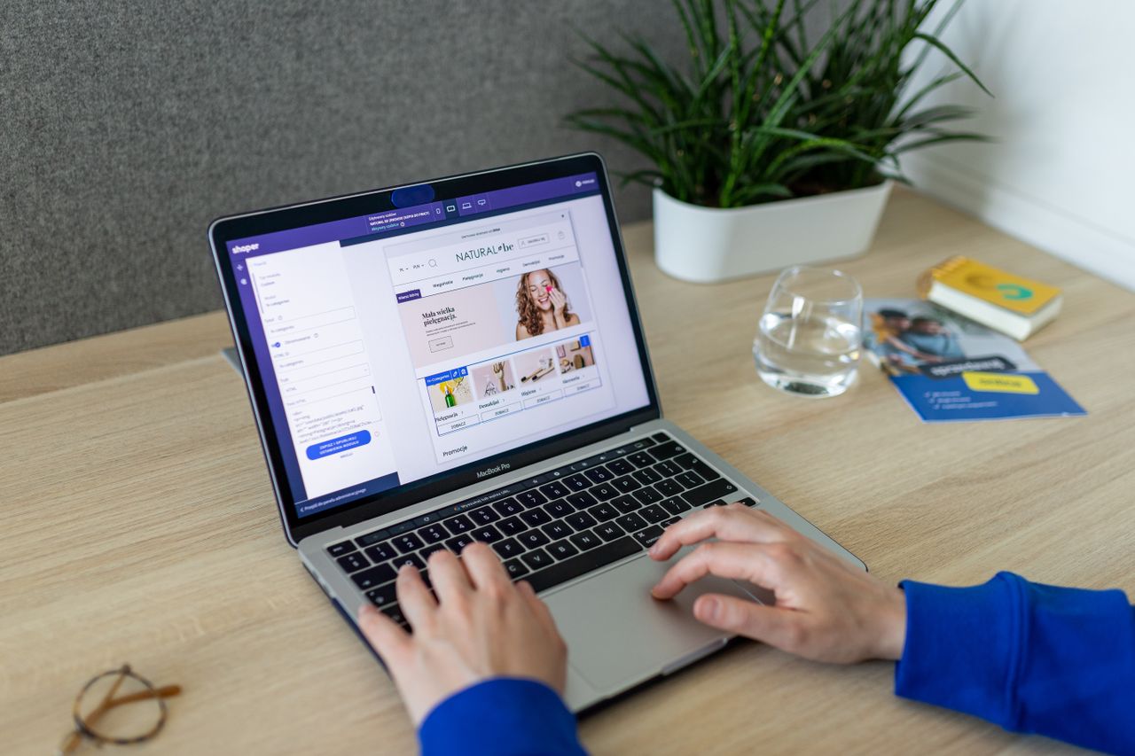 Crafting Captivating Headlines: Your awesome post title goes here A person navigating an online store on a laptop, at a modern indoor office desk.